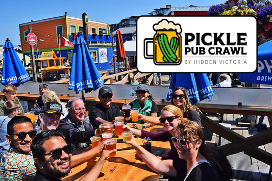 Group of people enjoying drinks at an outdoor bar with Pickle Pub Crawl logo overlay.