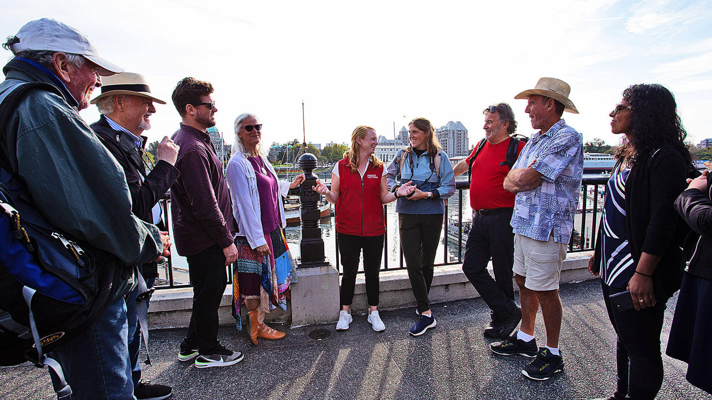Group of people standing on a bridge with a cityscape in the background